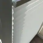 Miniaturka - Biały aluminiowy profil plisy okiennej dopasowany do ramy, sznurkowy detal montażu rolety w Kobyłce.