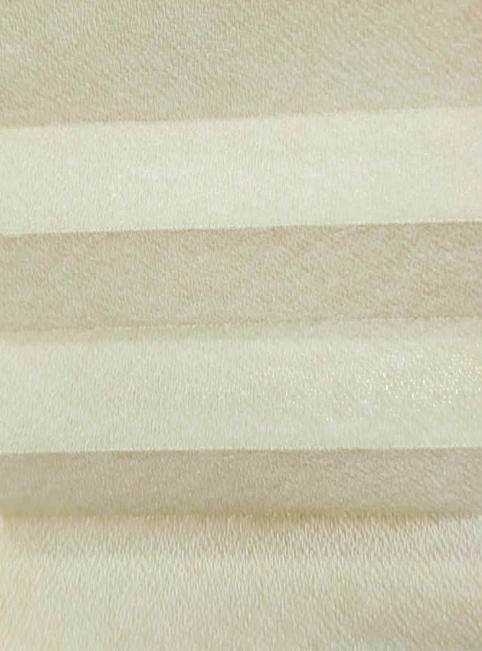 Close-up of cream-colored horizontal window blinds with a soft fabric texture.