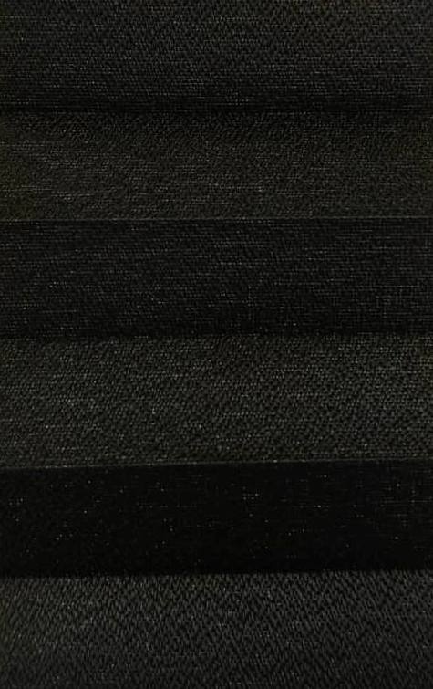 Close-up of dark charcoal fabric with horizontal pleats or bands.