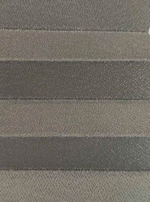 Close-up of horizontal brown fabric stripes with a textured weave, showing multiple shade bands.