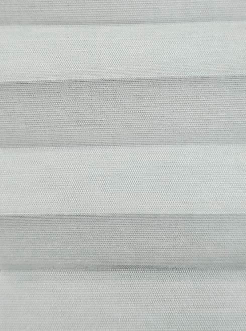 Close-up of light gray pleated fabric with horizontal folds.
